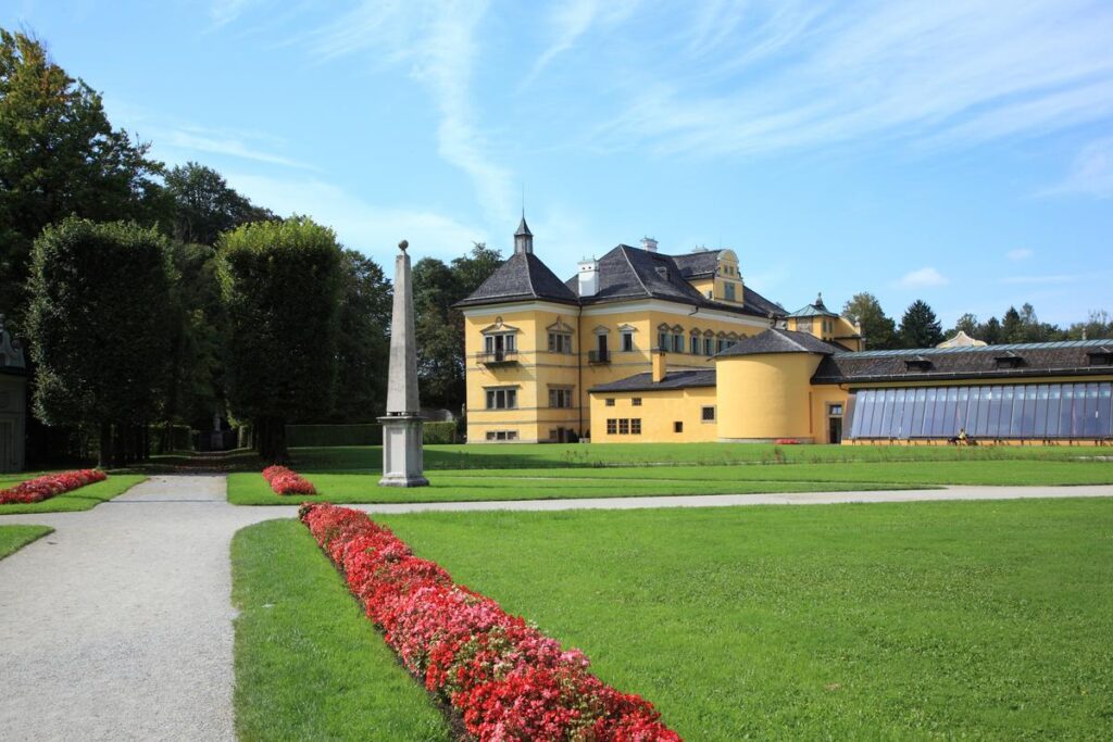 Schloss Hellbrunn in Salzburg with manicured gardens and historical architecture.