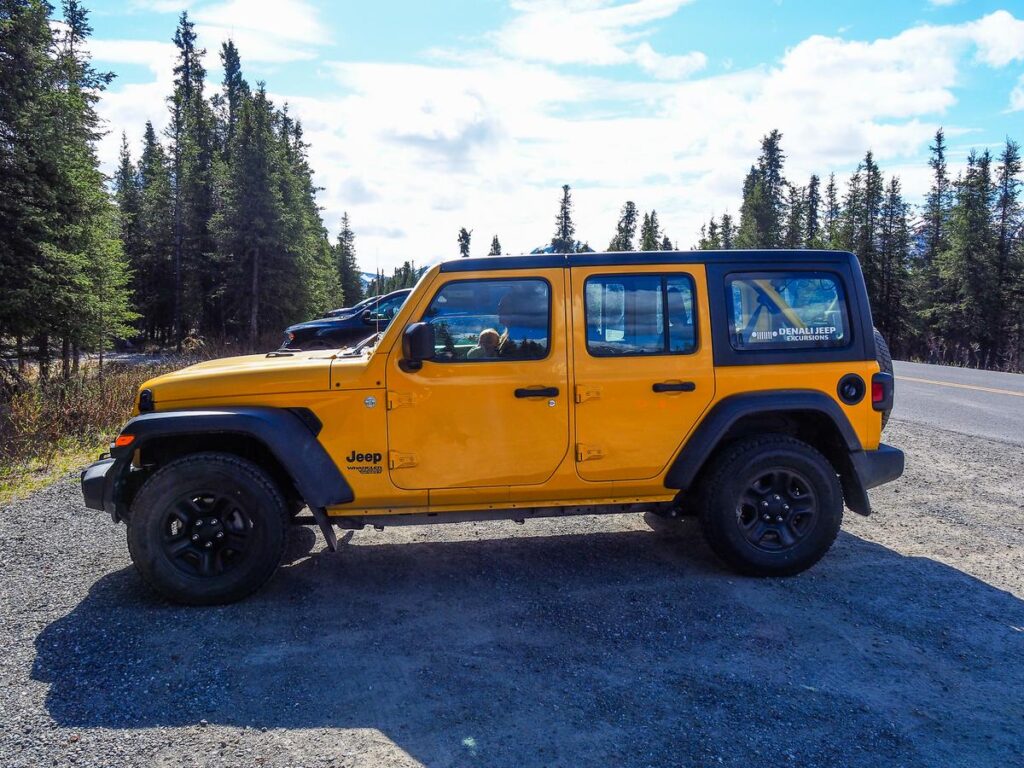 Bright yellow Jeep on Denali self-guided excursion in lush Alaskan wilderness