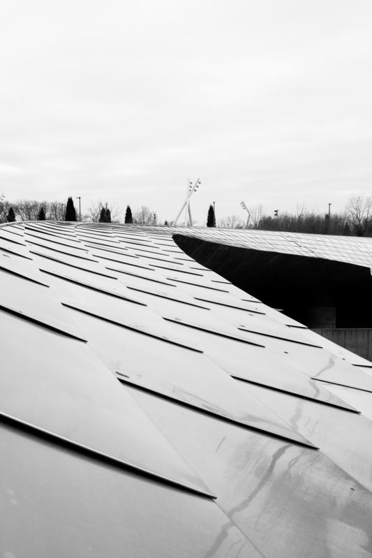 Sleek aluminium bridge at Millennium Park against overcast sky