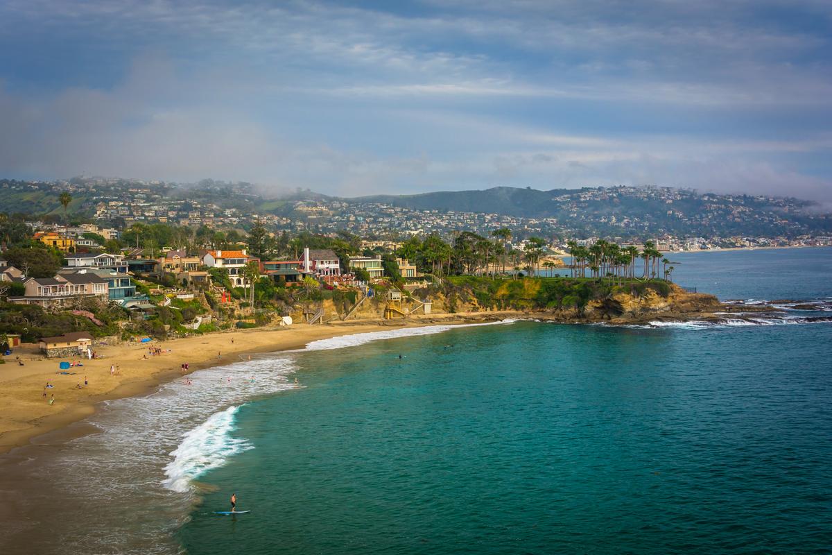 Breathtaking Pacific Coast panorama from Crescent Bay Point Park, Laguna Beach with lush hillside and serene beachfront.