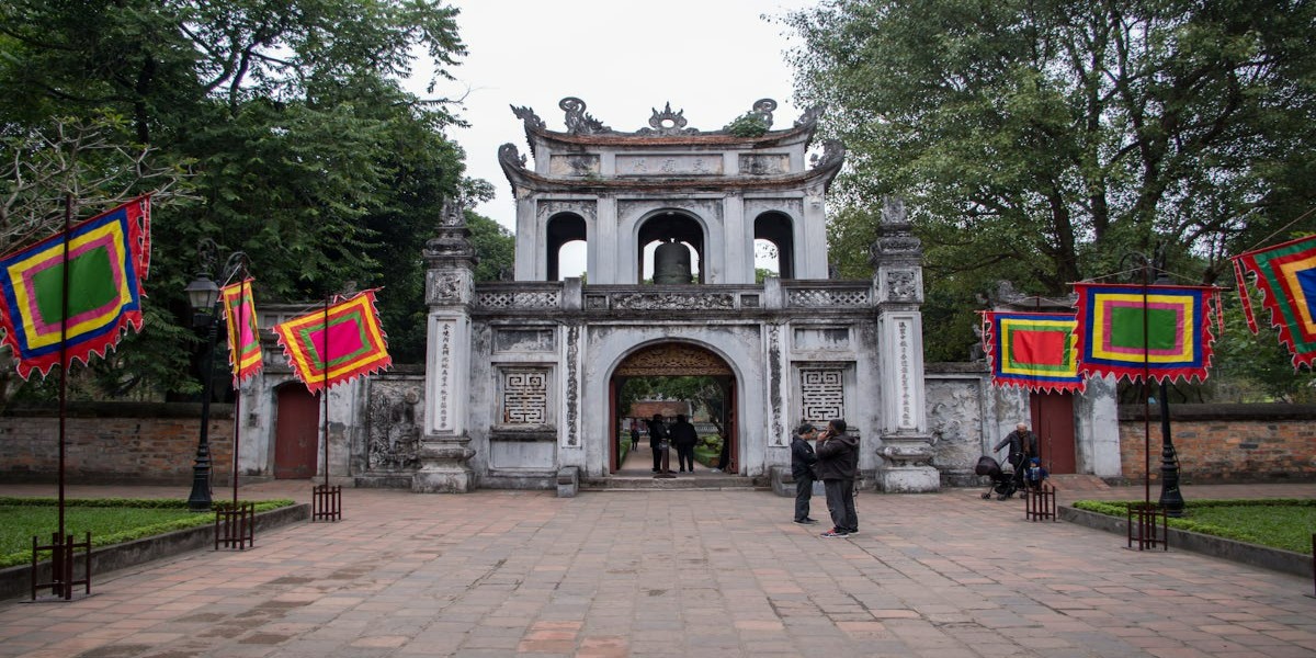 Tourists at the Main Gate of the Temple of Literature in Hanoi
