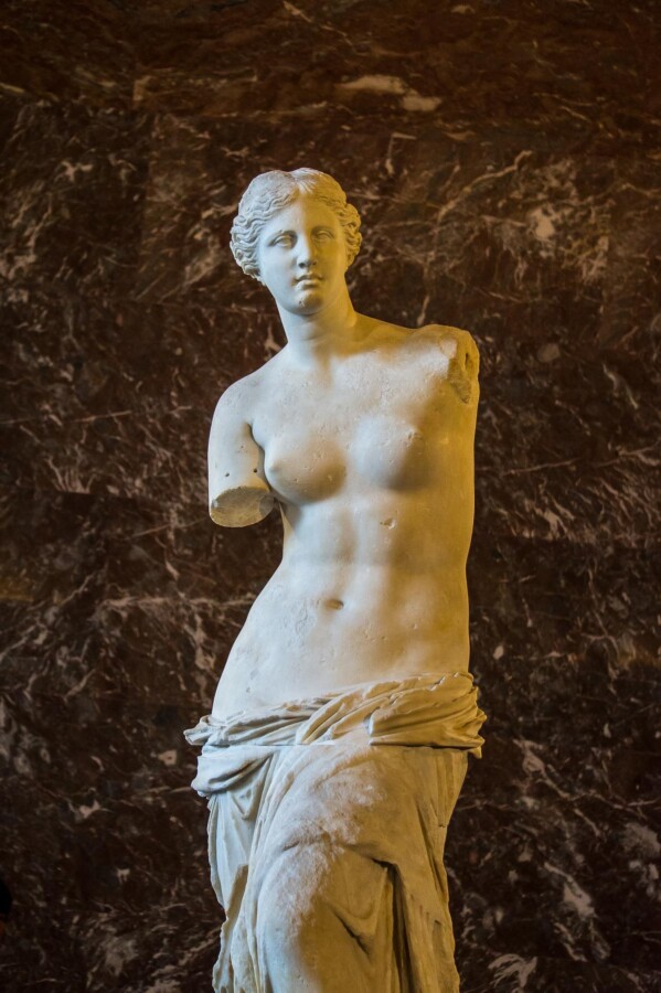 Ancient Greek sculpture Venus de Milo at Louvre Museum, Paris - A timeless masterpiece of Hellenistic art in marble.