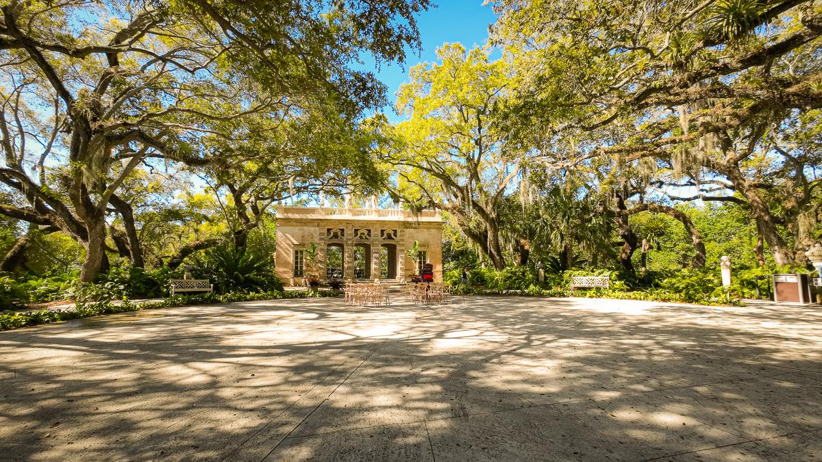 Sunny day at Vizcaya Museum and Gardens with lush trees and historic architecture in Miami, Florida