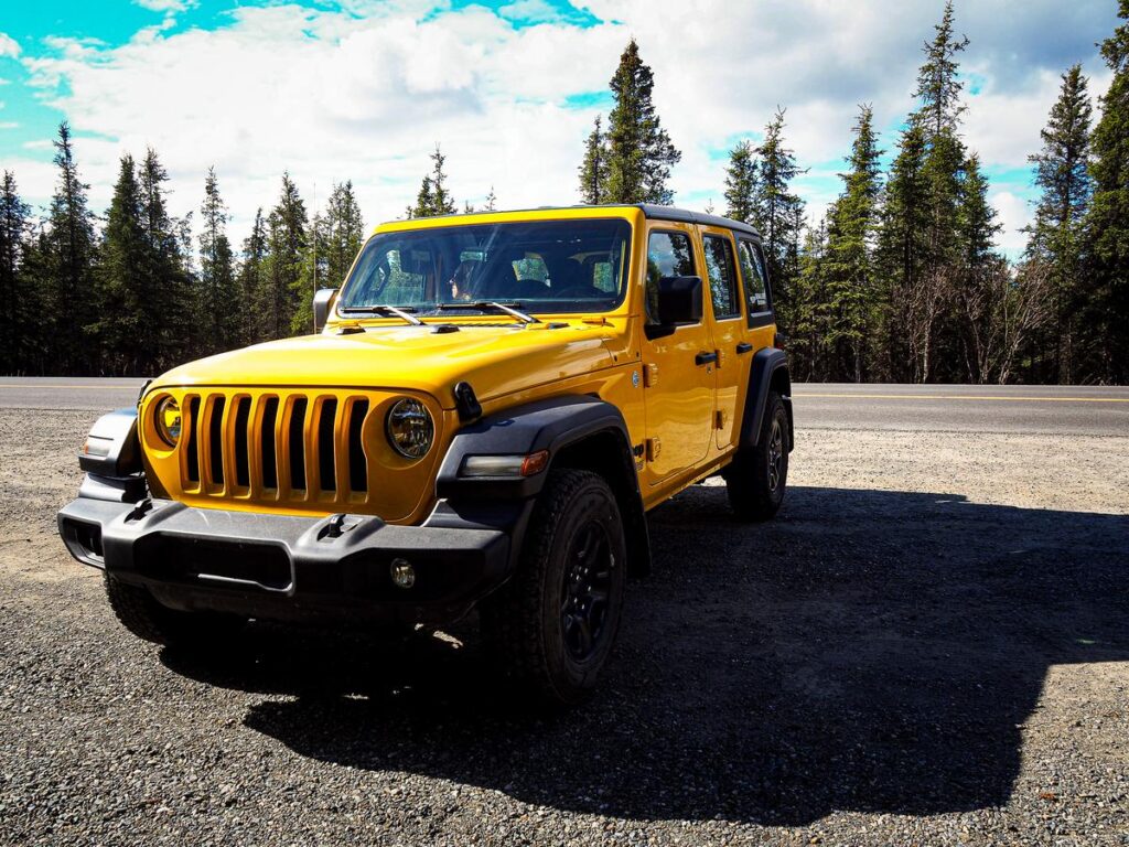 Yellow jeep parked on a scenic road in Denali National Park during a jeep tour