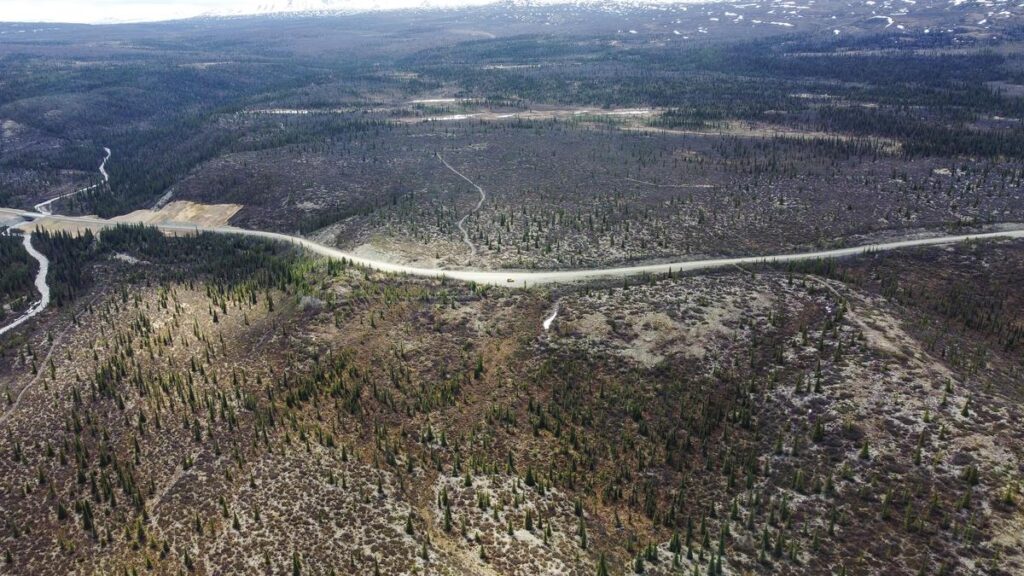 Stunning aerial view of Denali Highway winding through Alaskan wilderness