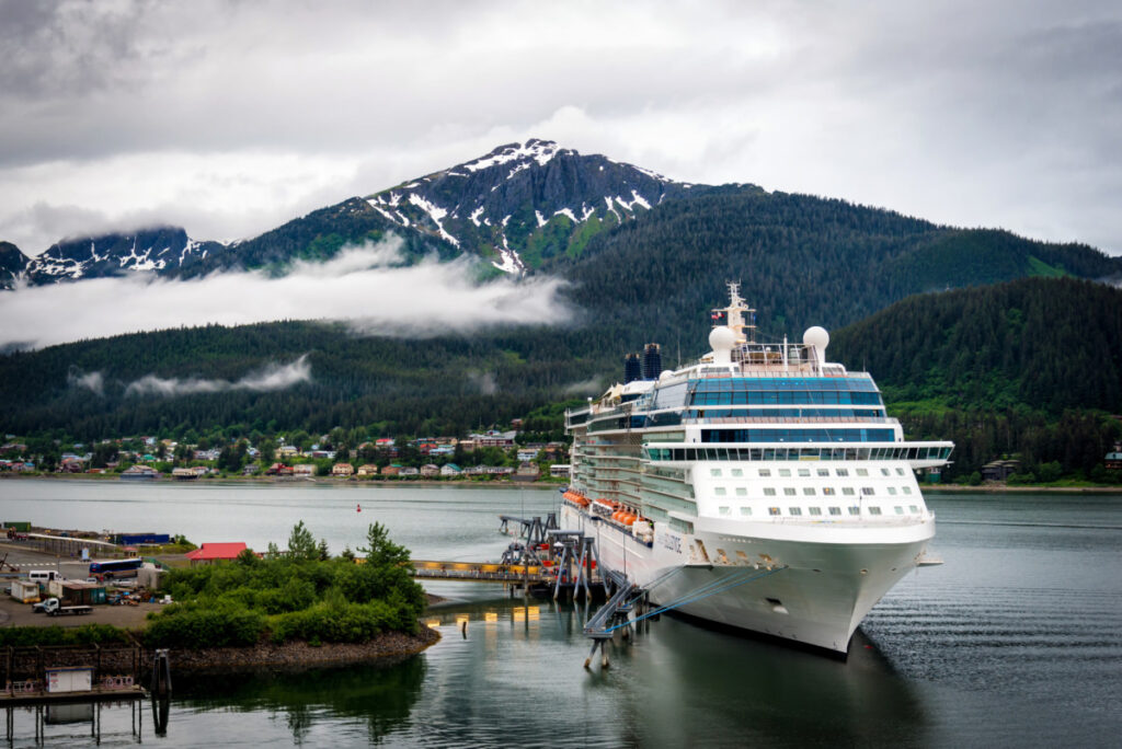Huge white cruise ship dock at a port in Juneau, Alaska