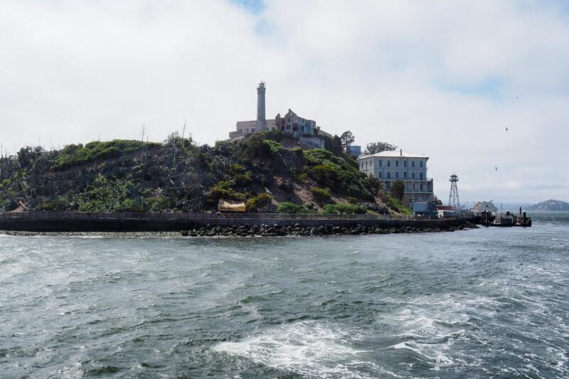 Alcatraz Island view with San Francisco Bay and misty hills backdrop