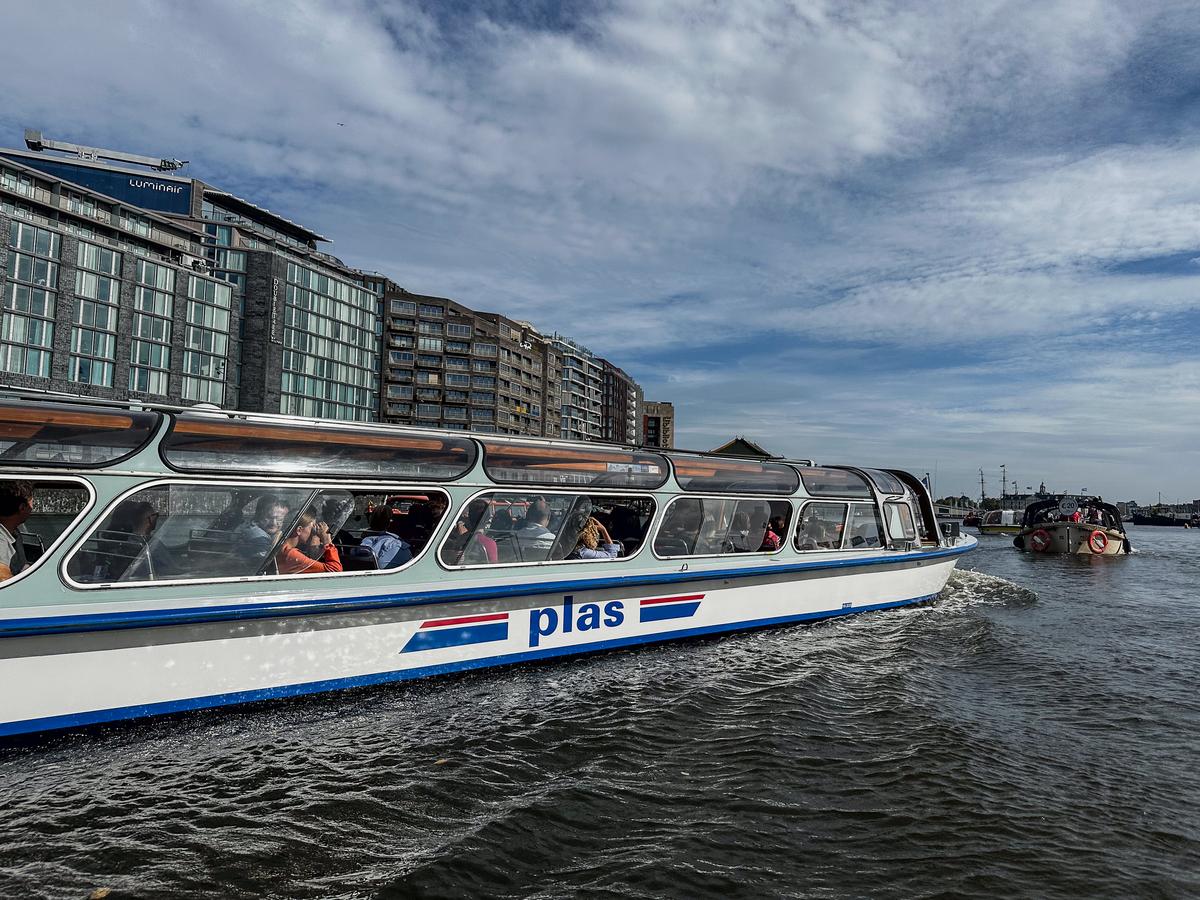 Amsterdam Amstel River boat tour with city views and tourists onboard