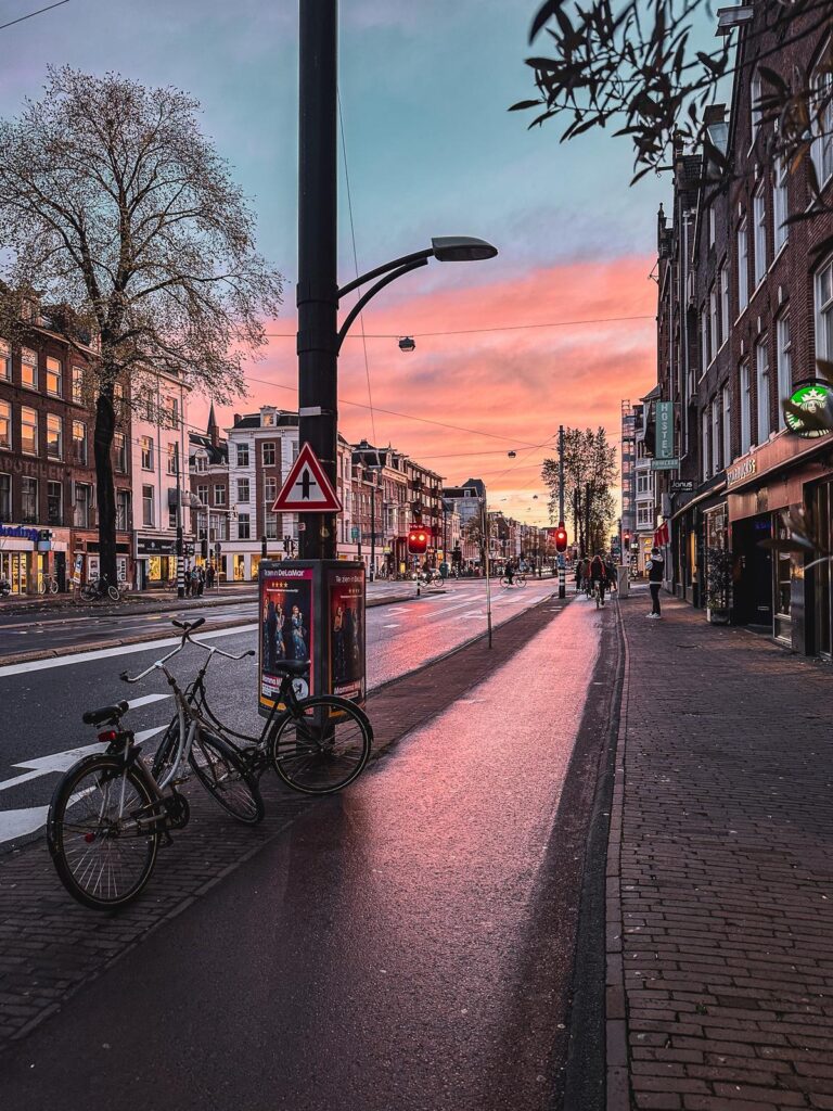 Amsterdam bike lane at sunset, showcasing hues and urban tranquility