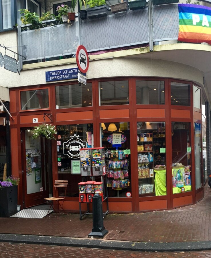 Colorful candy shop window among charming shops in Amsterdam.