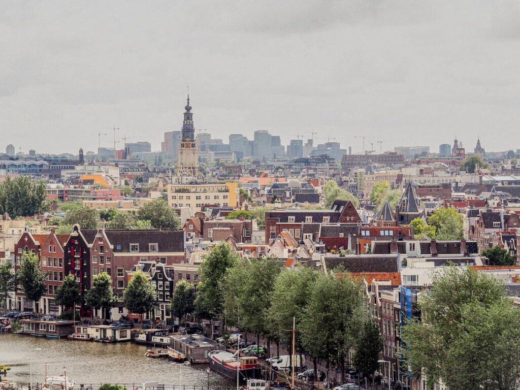 Amsterdam skyline with traditional rooftops, canals, and historic architecture