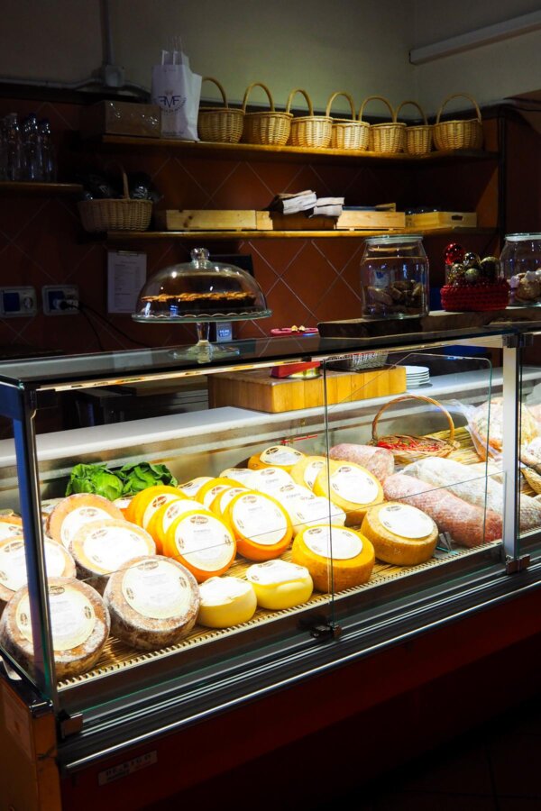 Artisanal cheese and cured meats display at Italian deli