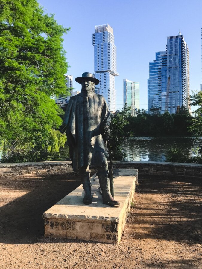 Bronze statue with Austin skyline backdrop