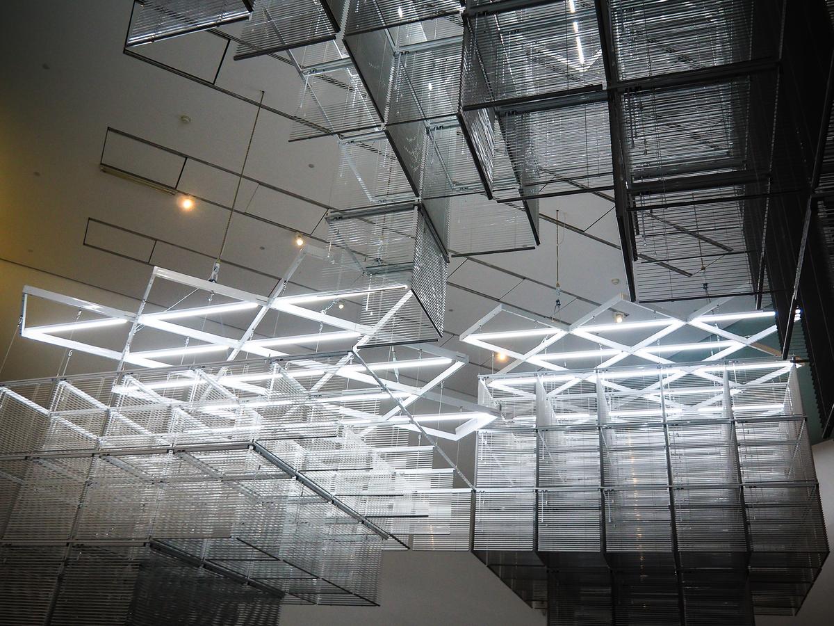 Avant-garde light sculpture at Tate Modern, London, creating dynamic play of light and shadow.