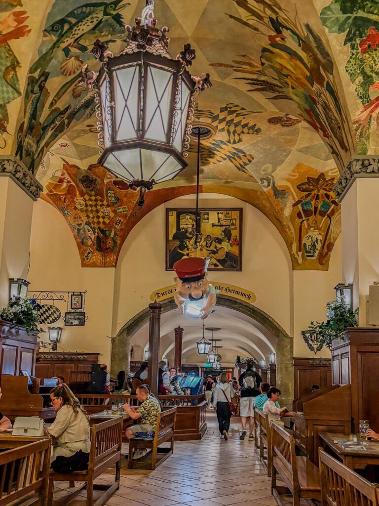 Interior view of Hofbräuhaus Beer Hall in Munich, Germany, showcasing traditional Bavarian folk art and vibrant atmosphere