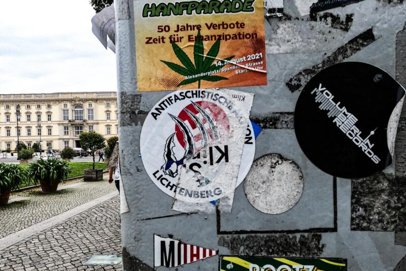 Berlin street pole with graffiti and stickers