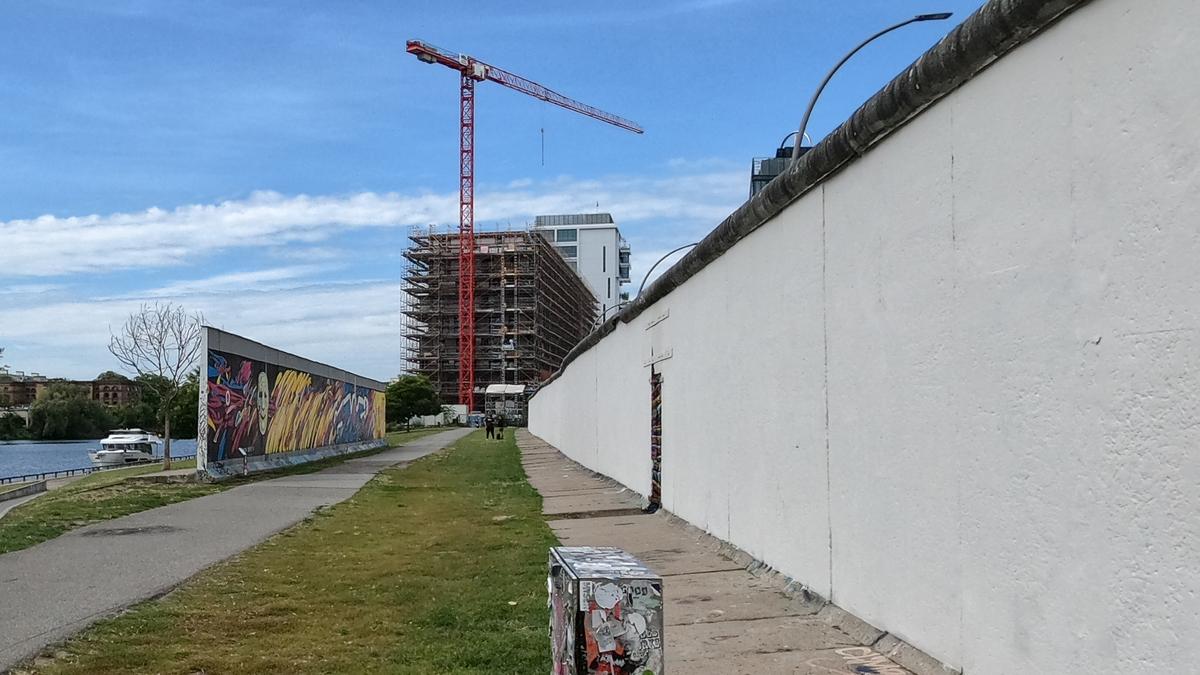 East Side Gallery Berlin Wall murals and construction contrast