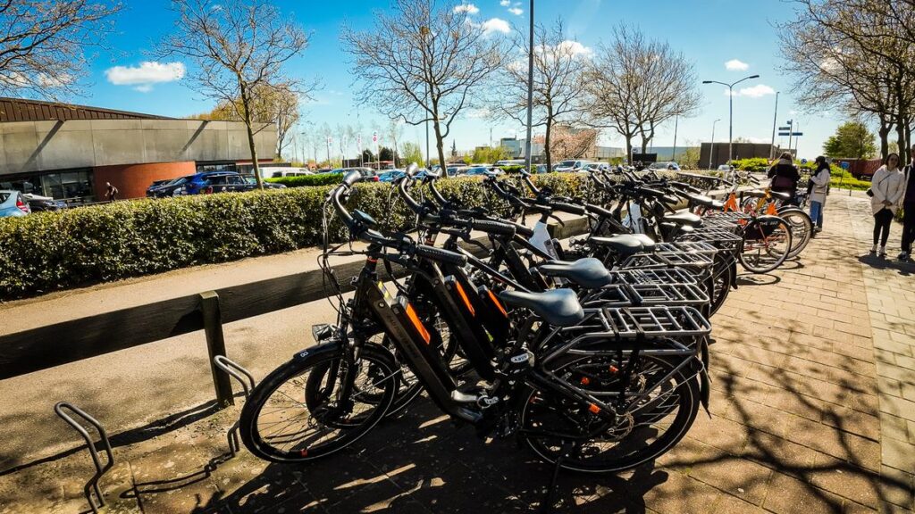 Bicycles parked under sunny skies near Zaanse Schans, Netherlands.