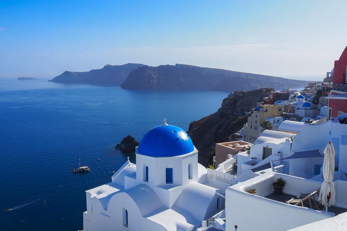 Santorini's iconic blue domes in Oia, Greece under a stunning Mediterranean sky