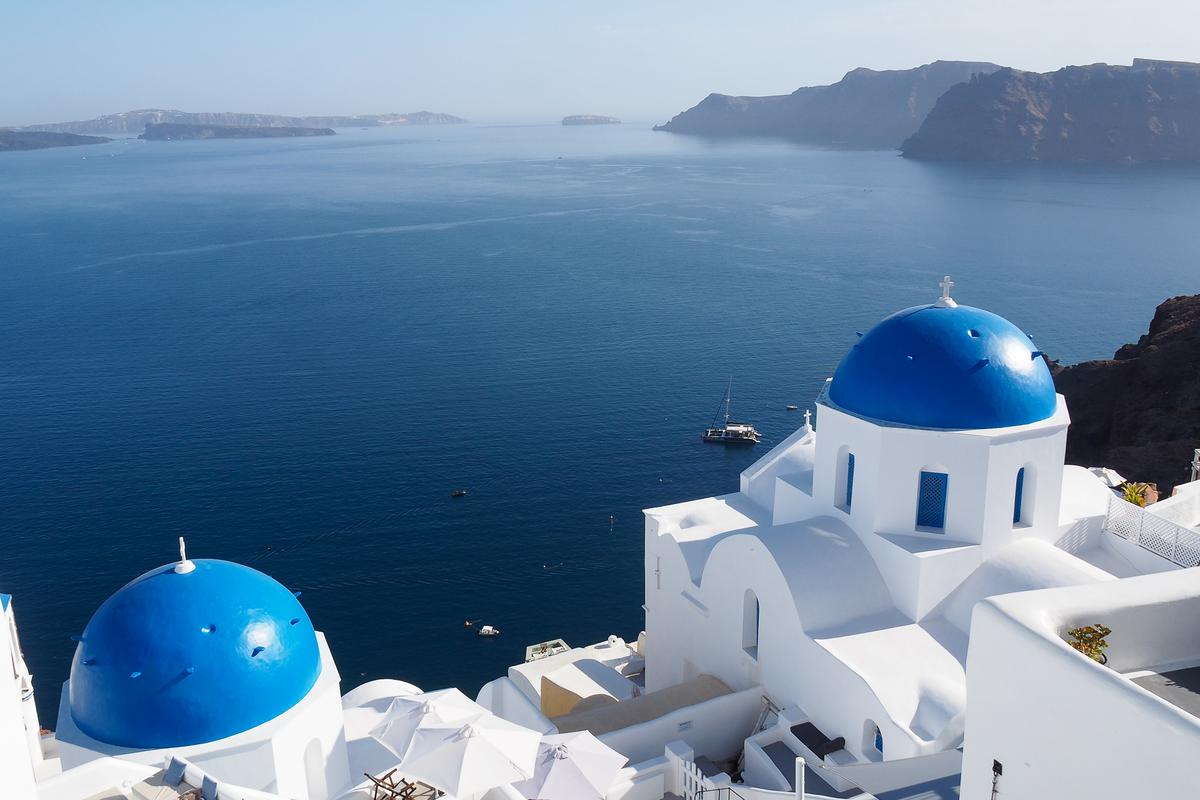 Stunning blue domes in Oia, Santorini overlooking Aegean Sea, Greece