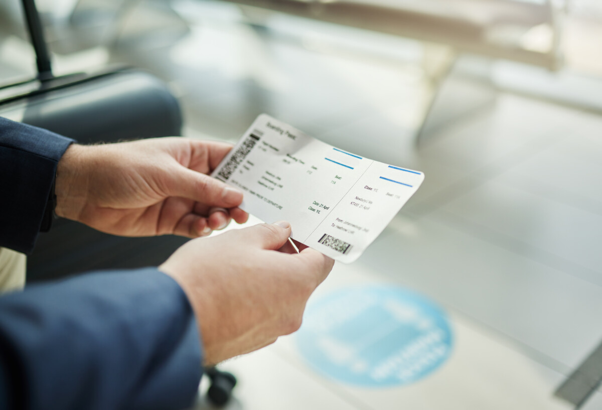 Man holding a plane ticket