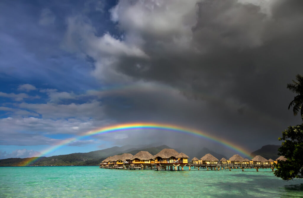 Dark clouds and rainbow after shower rain in Bora Bora