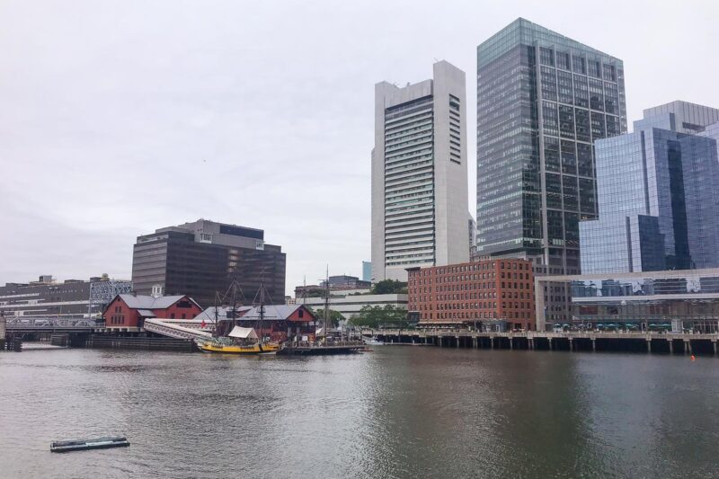 Boston Harbor skyline with historic sailing ship and modern buildings