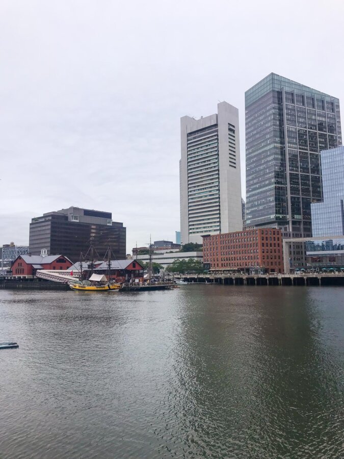 Serene Boston Harbor and city skyline with sailboat