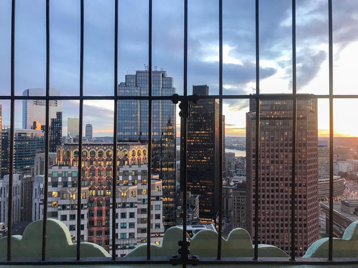 Boston skyline at sunset with waterfront reflections