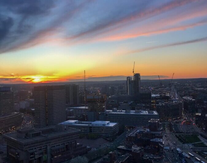 Sunset over Boston skyline with vibrant twilight hues
