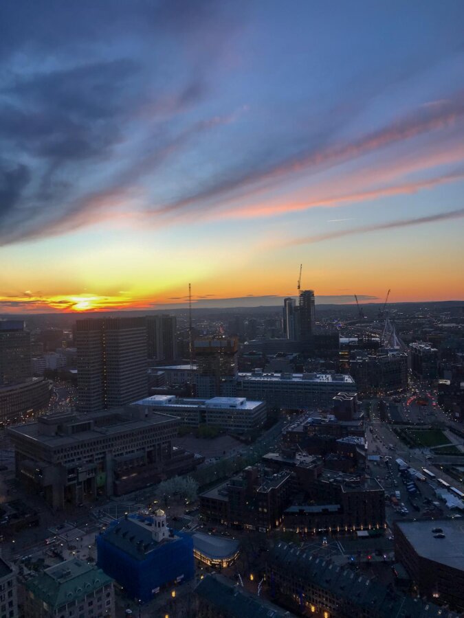 Sunset over Boston skyline with vibrant twilight hues