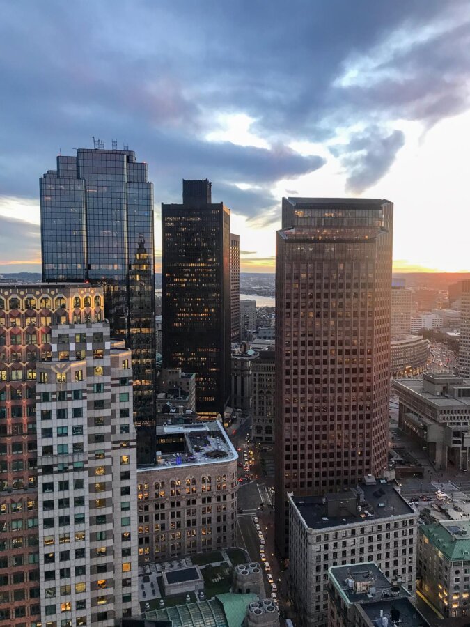 Boston skyline and skyscrapers illuminated by sunset hues
