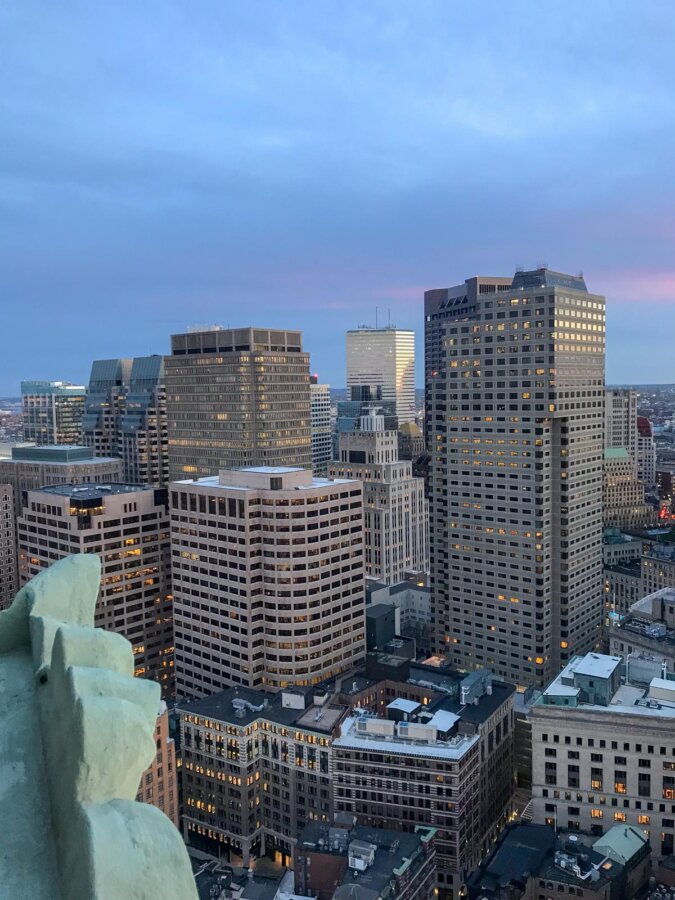 Boston skyline at sunset with glowing high-rises and pastel sky