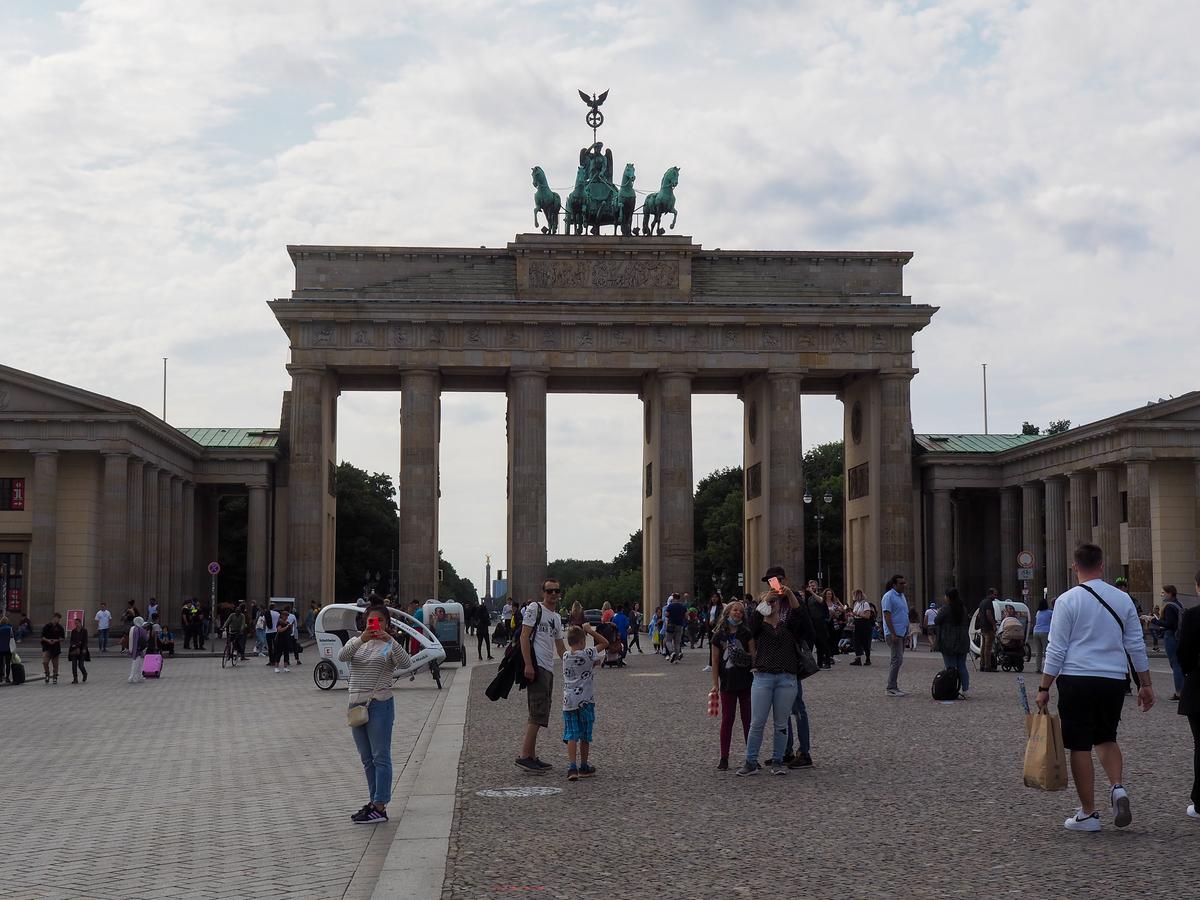 Visitors walking beneath the Brandenburg Gate in Berlin