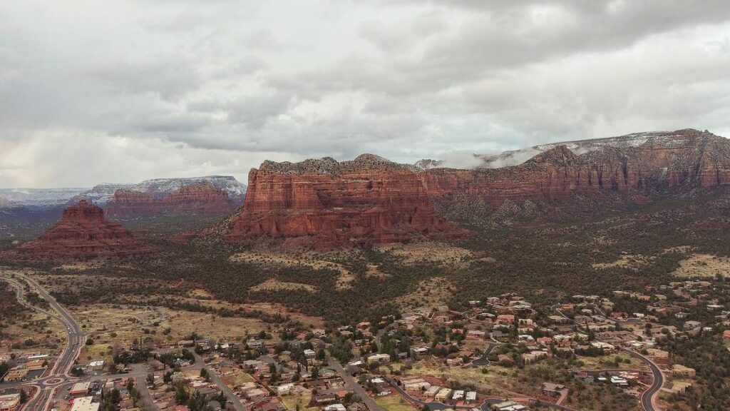 Aerial panorama of Sedona's iconic red rock formations and townscape landscape.