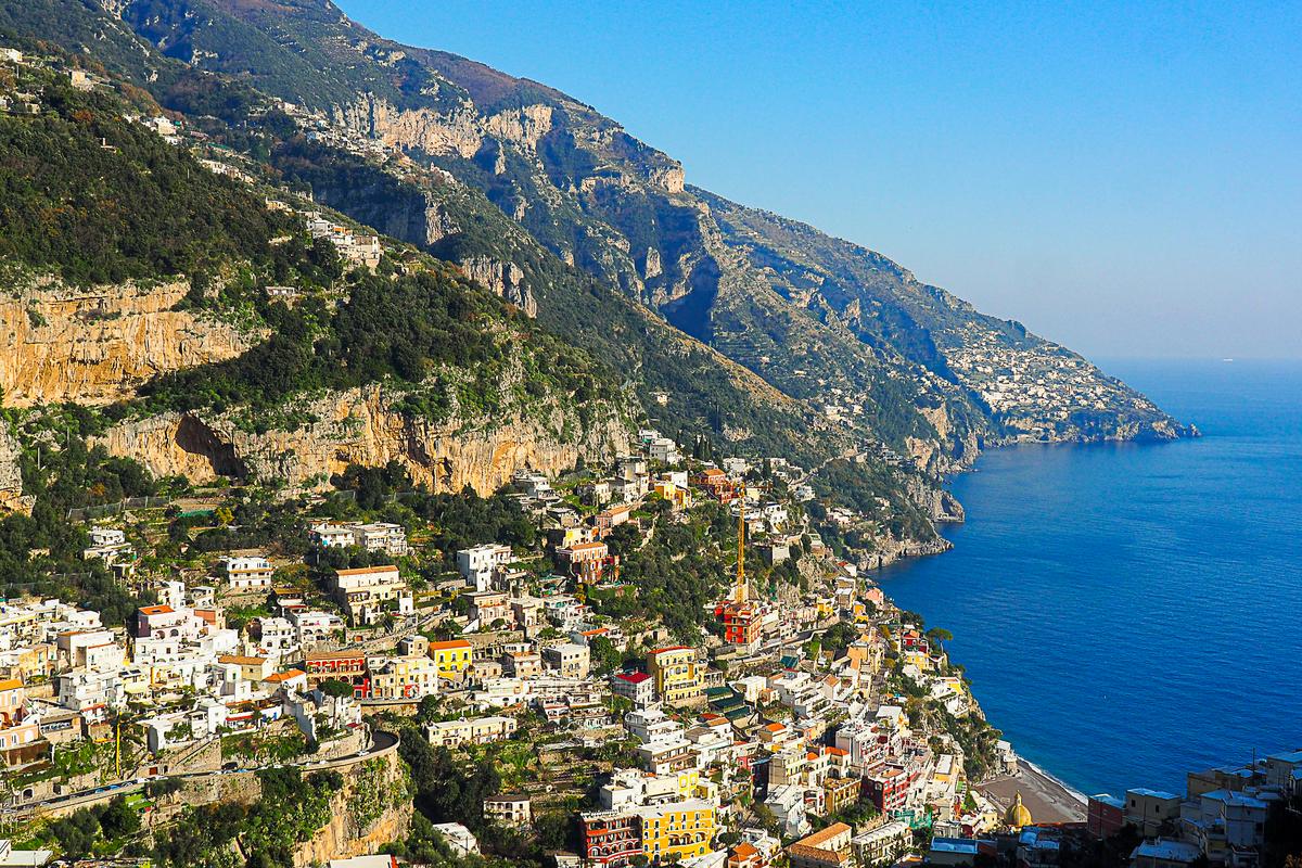 Breathtaking panoramic view of the Amalfi Coastline, showcasing rugged terrain, colorful architecture, and pristine waters.