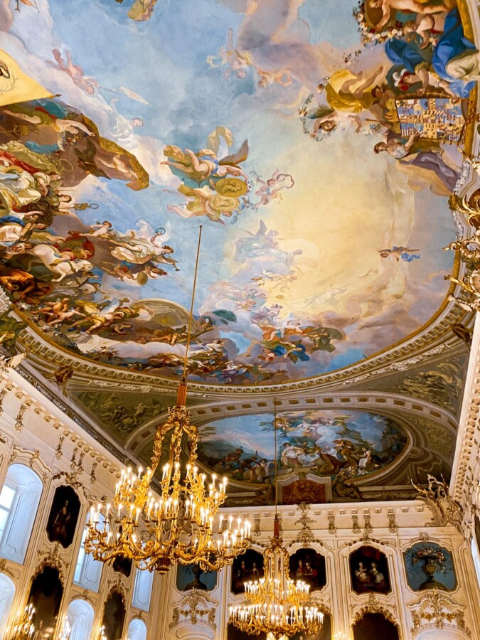 Breathtaking Baroque Interior of the Hofburg Palace in Innsbruck: Opulent design, frescoes, chandeliers, and artistry.