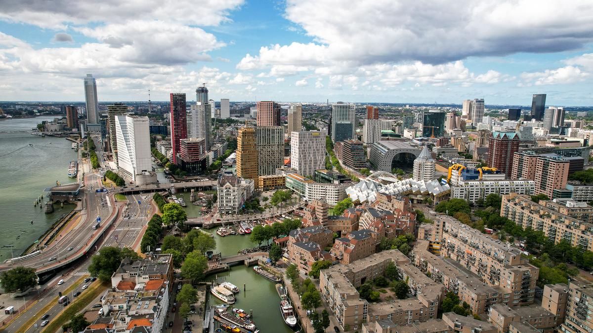 Breathtaking Aerial View of Rotterdam Skyline and Cityscape - Erasmus Bridge, Modern Skyscrapers, and Historical Buildings