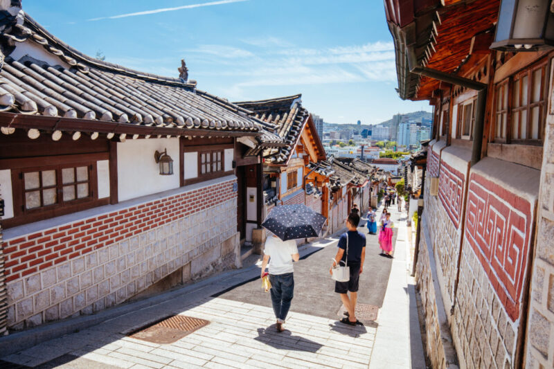 Bukchon Hanok Village, Seoul near Gyeongbok Palace: traditional hanok street with sunlit alley.