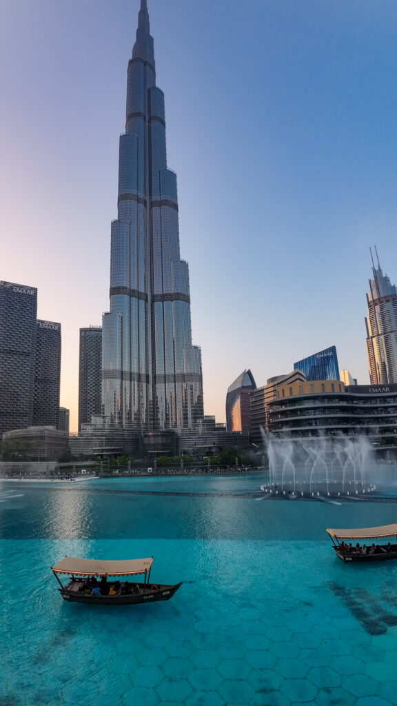 Burj Khalifa and Dubai Fountain Show with Traditional Abra Boats at Twilight in Downtown Dubai