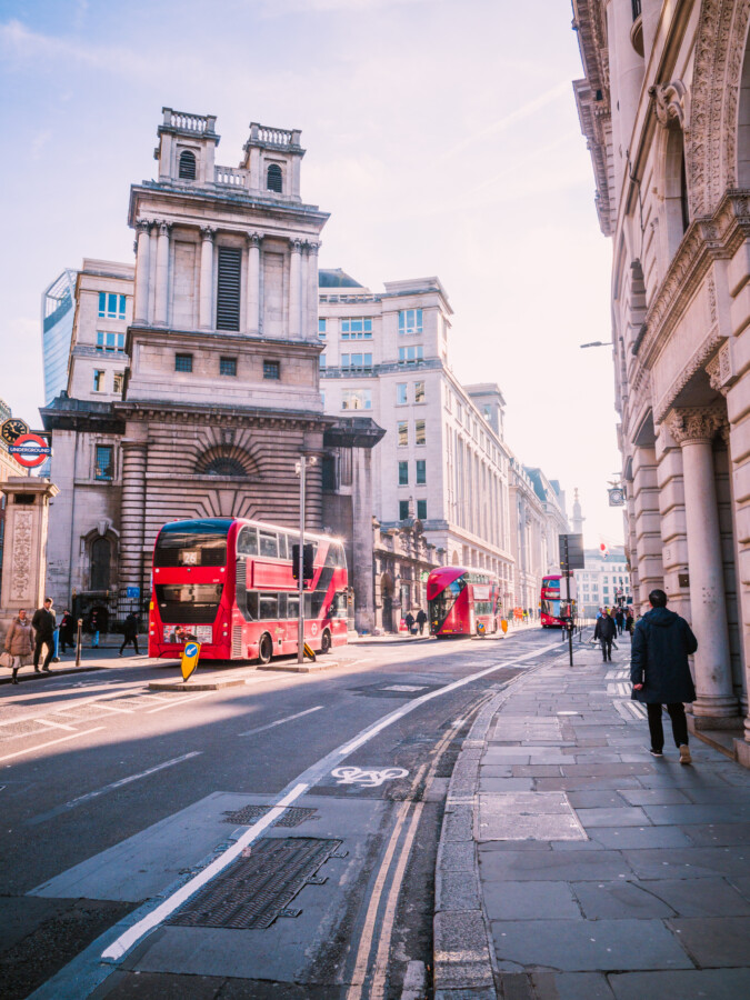 Red double-decker buses on a street in the City of London