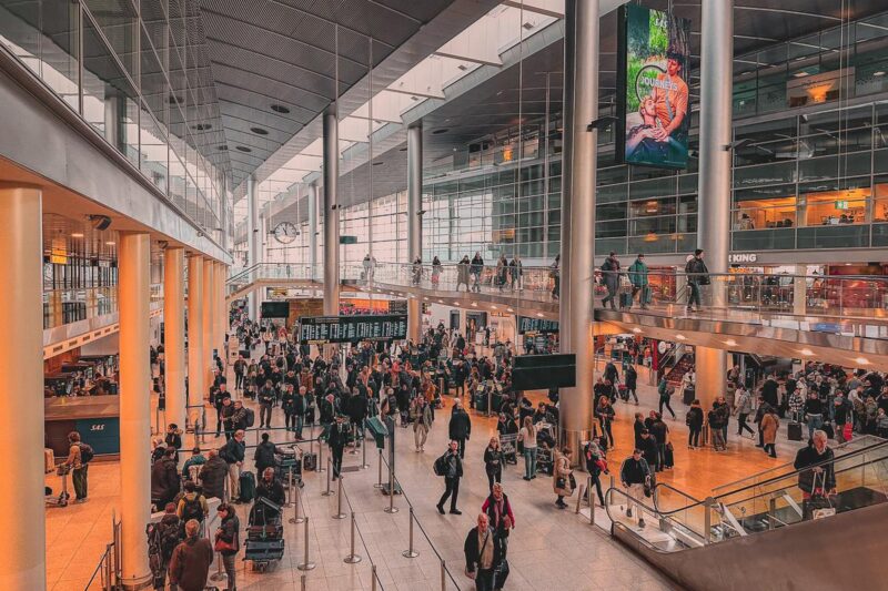 Bustling Copenhagen Airport Terminal - Modern architecture, travelers, sRGB color photography, Journeys advertisement