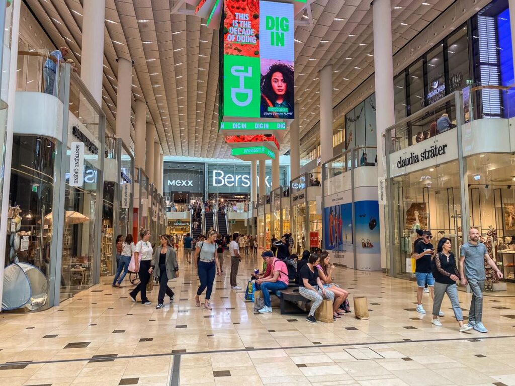 Bustling Shopping Experience at Hoog Catharijne Mall in Utrecht, Netherlands - Premier shopping destination with diverse stores and eateries, modern architecture, and international brands.