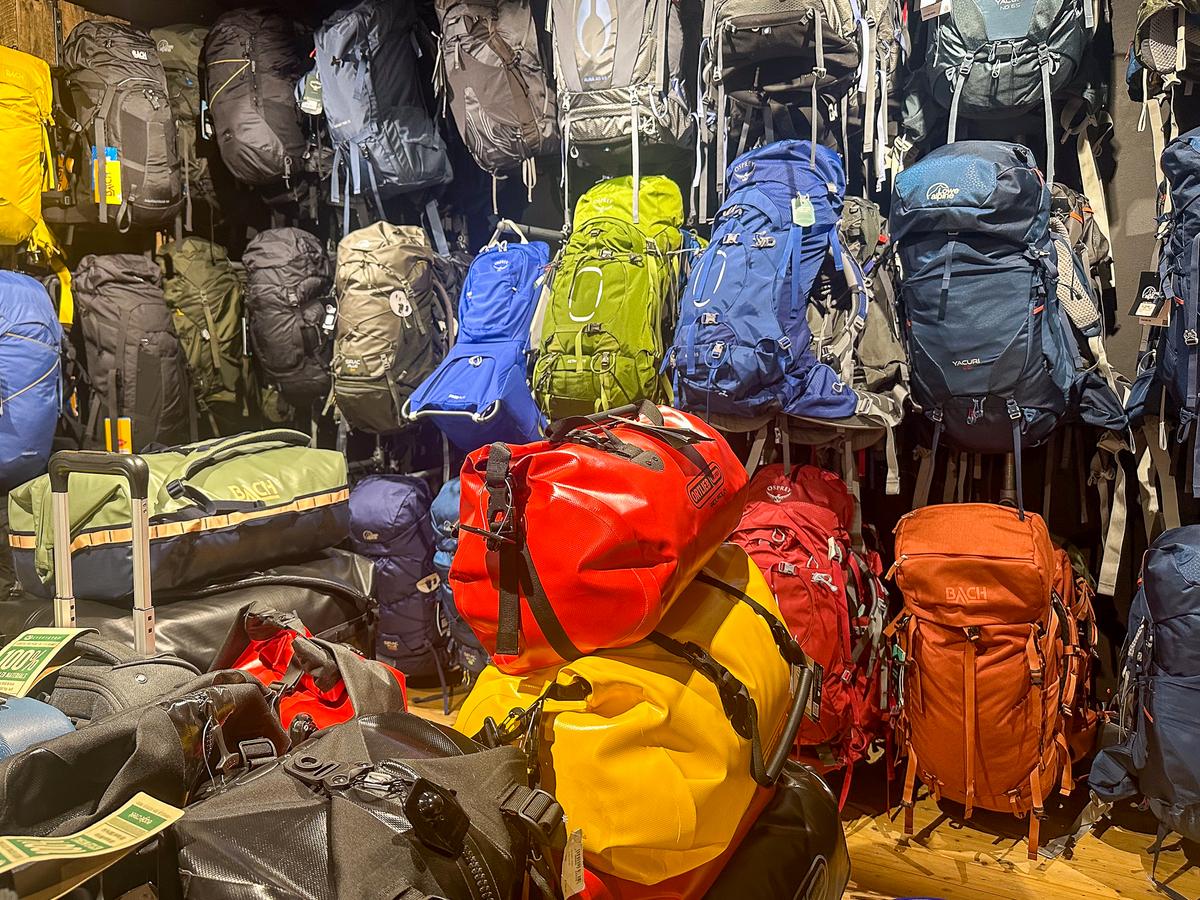 Outdoor display of colorful camping and hiking backpacks for adventure travel gear