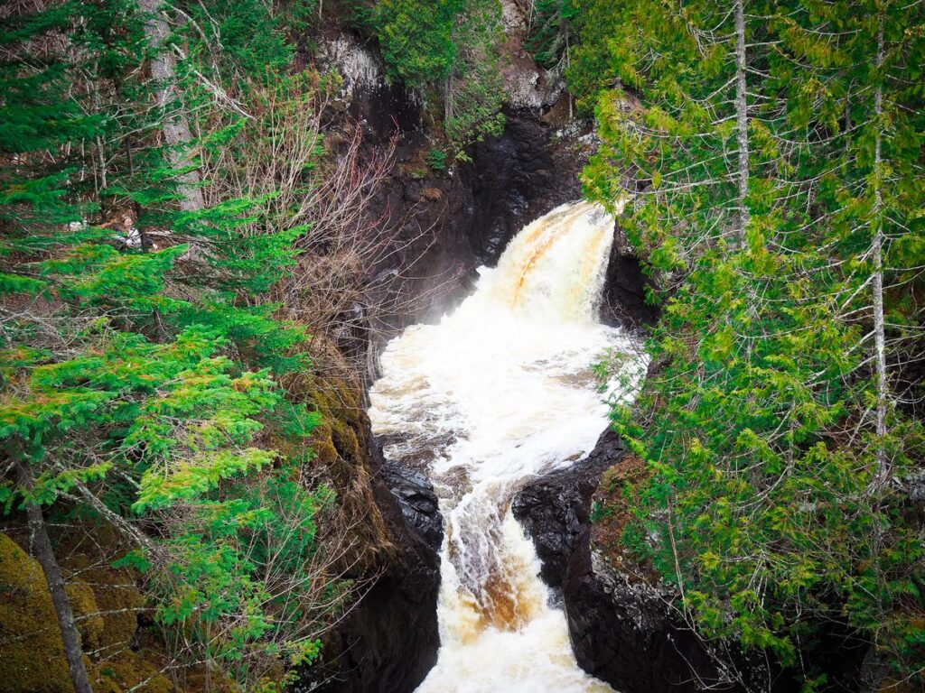 Aerial view of Cascade River State Park waterfall surrounded by greenery in Minnesota