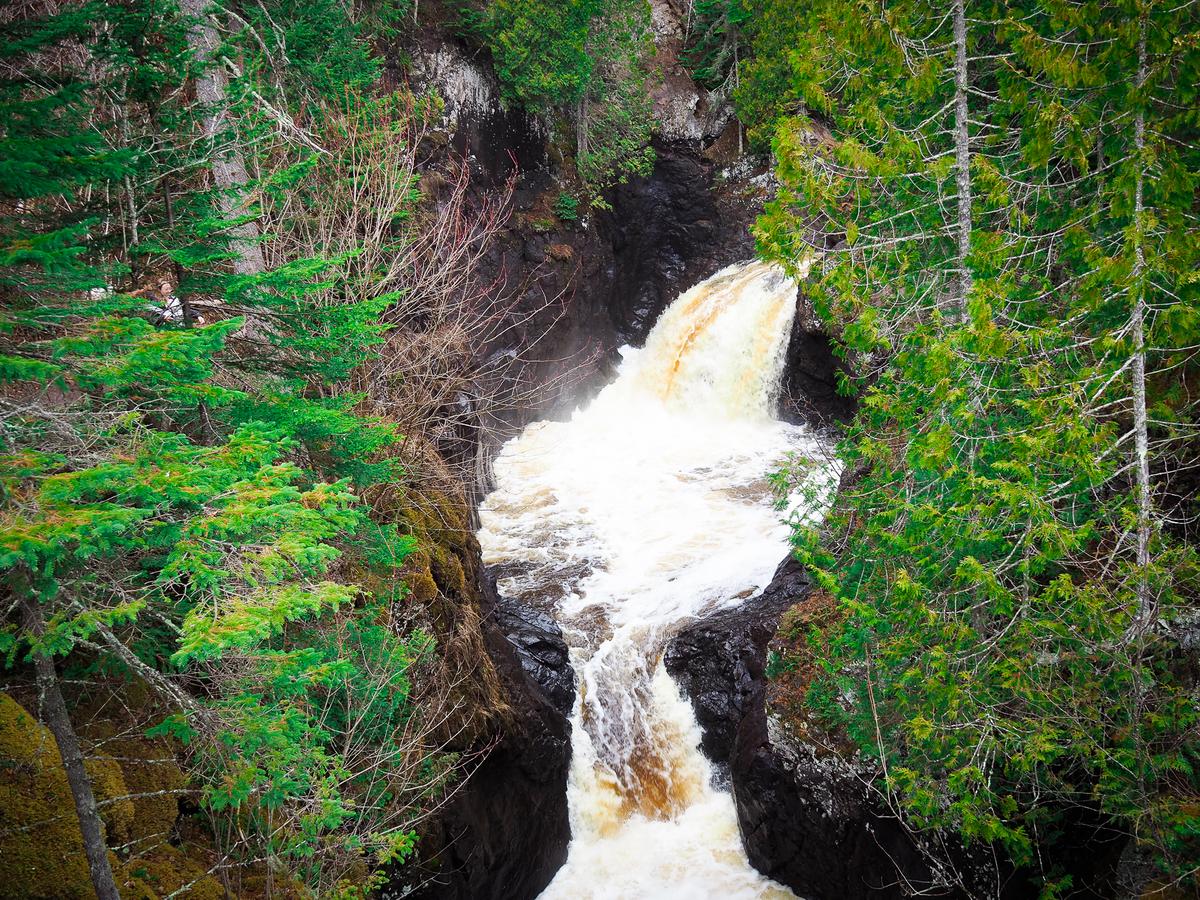 Aerial view of Cascade River State Park waterfall surrounded by greenery in Minnesota