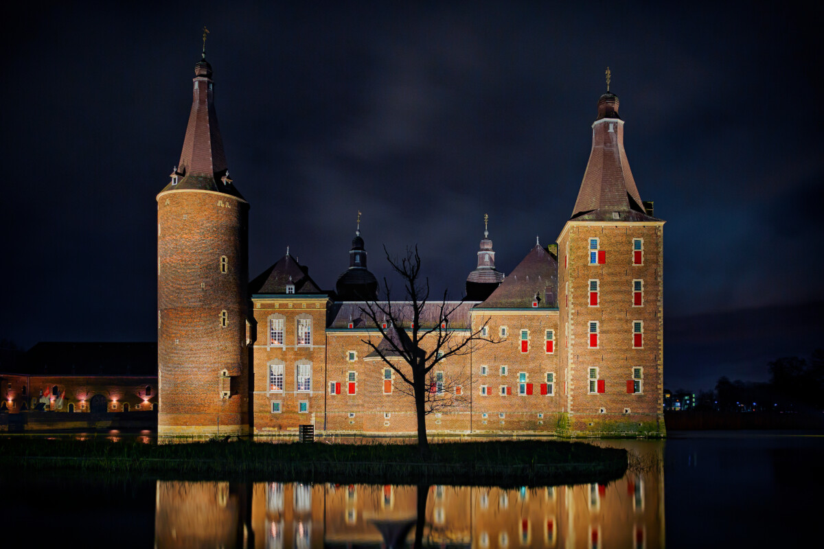 Hoensbroek Castle illuminated at night in Limburg, Netherlands
