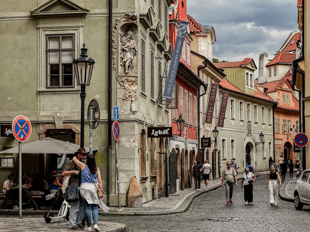 Charming cobblestone streets near Charles Bridge, Prague, with baroque architecture and bustling street life.