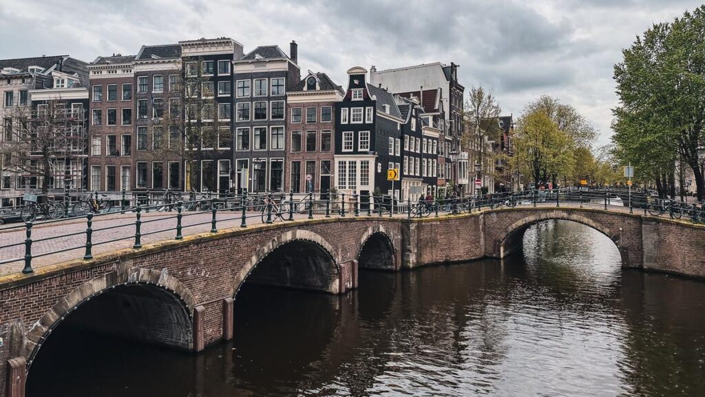 Charming Reguliersgracht canal in Amsterdam with historic Dutch architecture and serene waterway.