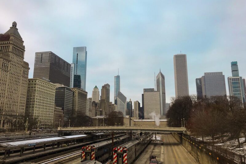 Chicago skyline at sunset with train tracks, urban architecture, transportation